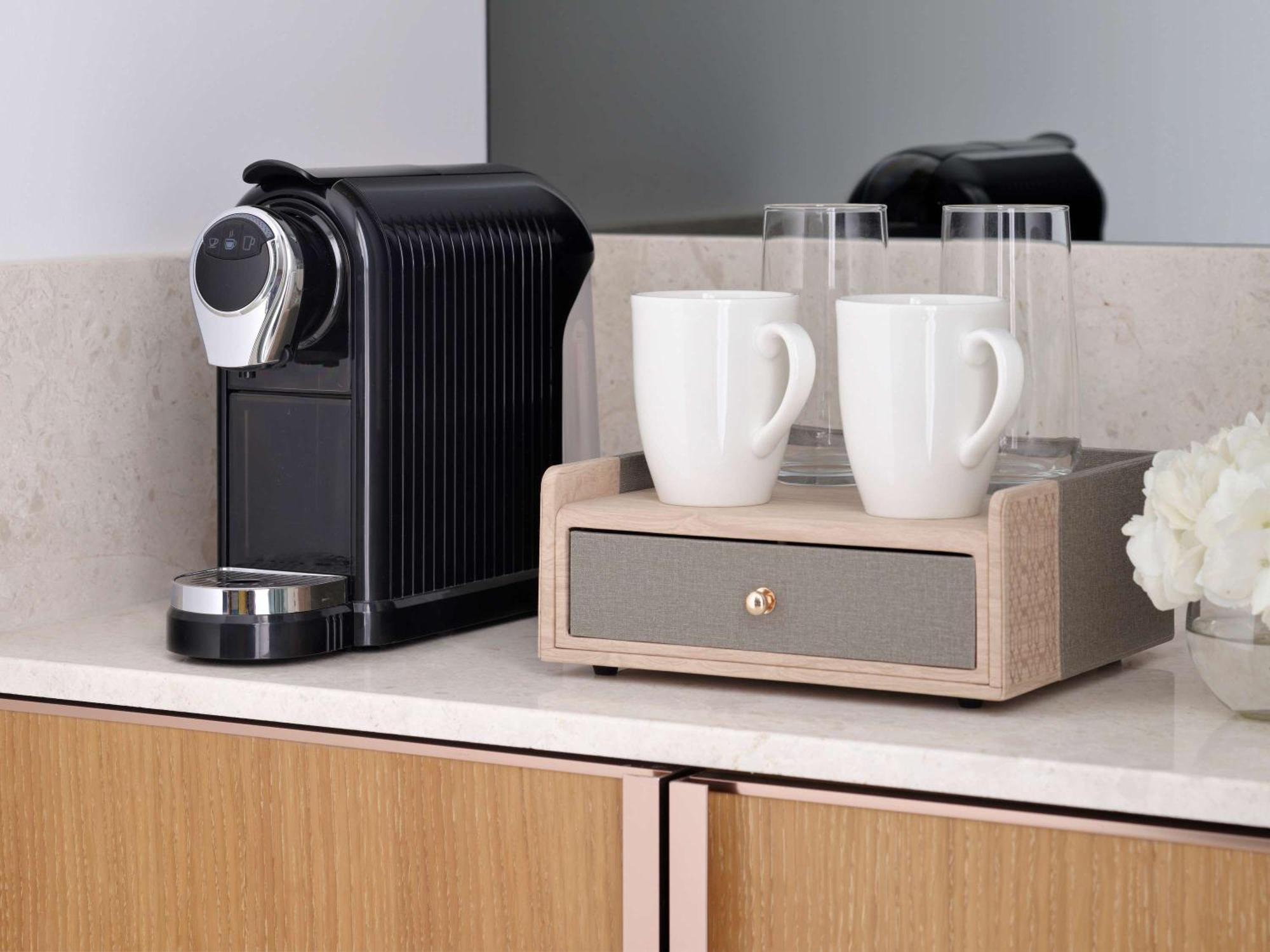 Moevenpick Hotel & Apartments Ghala Muskat Bagian luar foto A Nespresso coffee machine