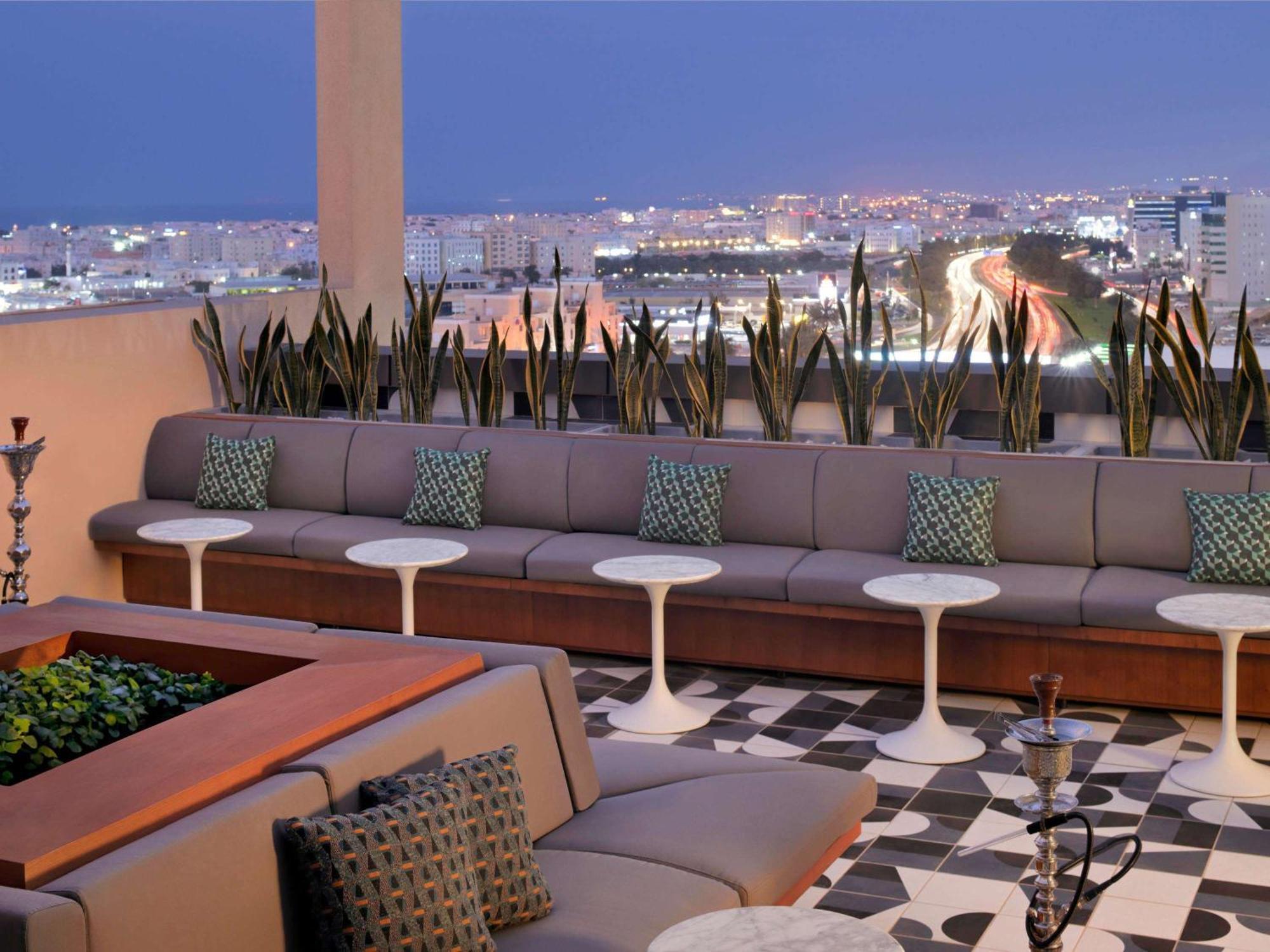 Moevenpick Hotel & Apartments Ghala Muskat Bagian luar foto The rooftop lounge at the Hotel Indigo