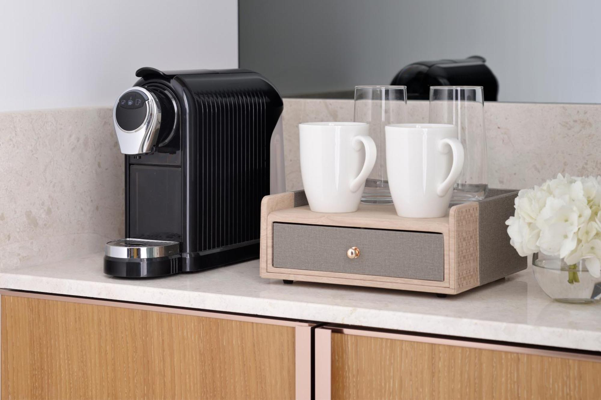 Moevenpick Hotel & Apartments Ghala Muskat Bagian luar foto A Nespresso coffee machine