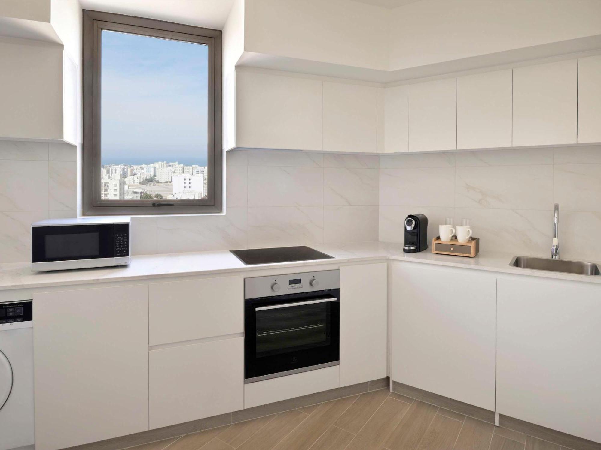 Moevenpick Hotel & Apartments Ghala Muskat Bagian luar foto A typical kitchen in a student apartment